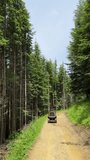 Man riding on ATV quad bike in mountain. Tourist on quad bike on beautiful nature background. People, leisure and vacation concept. Vertical video