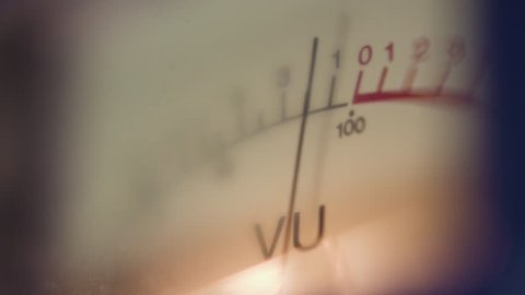 Analog measuring device with the needle in motion, studio closeup - vu / level audio meter. Volume Unit (VU)