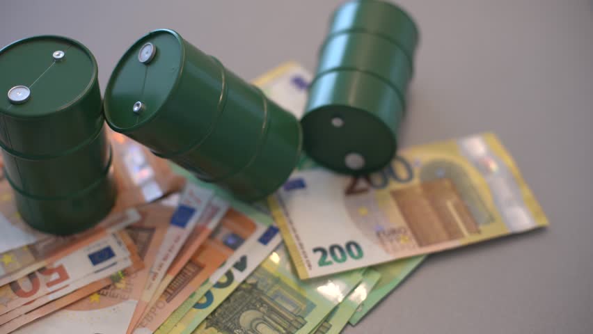 oil barrel with money, euro banknotes closeup