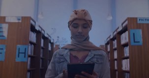 Animation of ai text and data over biracial female student in hijab with tablet. Global artificial intelligence, connections, computing and data processing concept digitally generated video.