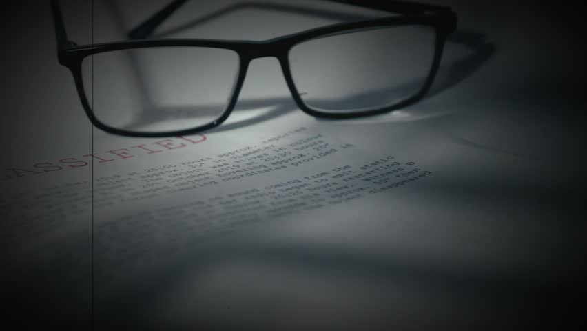 Top secret document with pair of glasses in damaged film vintage style 4k dolly selective focus