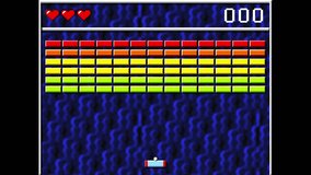 Enjoying the digital arcade game from the nineties. Destroying the blocks of various colours in the old digital arcade game. Retro Digital arcade game with a blue wavy background. Nostalgic.