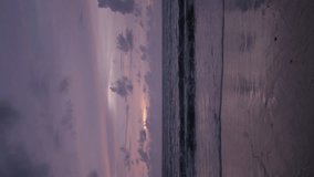 vertical video of sea coast white sand smooth beach with turquoise tropical water sea with some wave in sunset vanilla sky ,tropical nature summer landscape,vacation holiday background