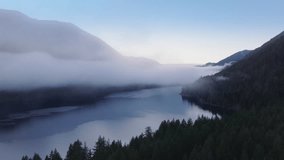 Olympic National park landscape on frosty winter evening. Scenic Washington nature with foggy rainforest. Lake Crescent aerial at twilight. Cinematic cloud mist flying above mirror like mountain lake - Powered by Shutterstock - Get 15% off with code: PIKWIZARD15