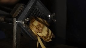 Slow motion video of a stick potato cutting device