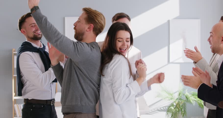 Happy dancing office business people in formal wear celebrating special occasion at work to unify coworkers. Event to entertain, engage business crew, company gathering for rest, fun Royalty-Free Stock Footage #3448954933