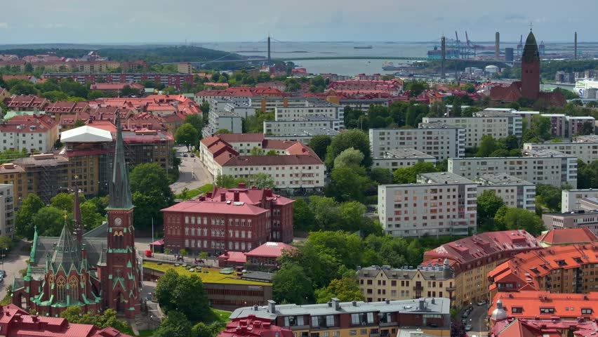 Scenic aerial view of the Old Town with Oscar Fredrik Church in the gorgeous sunset, Gothenburg, Sweden. rooftops panoramic view, Klippan port in Gothenburg harbor in afternoon, Famous bridge 