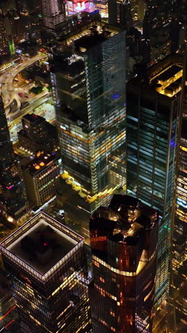 Dazzling panorama of marvelous New York at night. Drone footage over the vibrant city full of light. Vertical video.