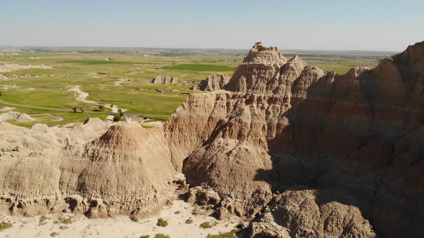 Badlands National Park, South Dakota USA. Aerial View, Butte and Pinnacles Rock Formations and Green Grassland on Sunny Day, Drone Shot