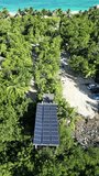 Solar panels on the beach, showcasing ecological methods that contribute to saving our planet. Solar energy represents the future, and that future is now. Incorporate these aerial videos in your ideas
