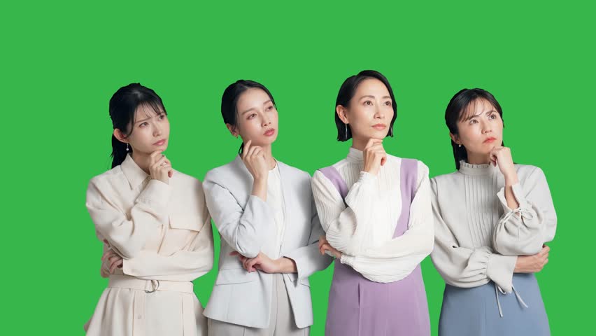 A group of Asian women talking while watching something. Green background for chroma key composition. Royalty-Free Stock Footage #3449127861