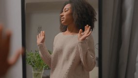 Unhappy African American woman looking in mirror reflection at home wear jumper casual style unhappy bad choice clothes quality apparel outfit dissatisfied customer girl in clothing shop dressing room - Powered by Shutterstock - Get 15% off with code: PIKWIZARD15