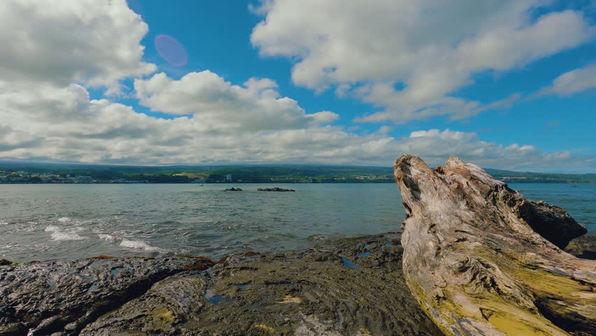 Hilo Bay Hawaii time-lapse. Partially cloudy days over Mauna Kea. The sun rays come and go.
