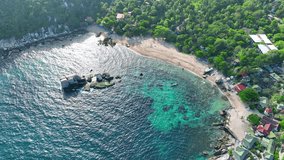 Explore Koh Tao's idyllic shores, snorkel through coral gardens, and soak up the island's laid-back vibe. Bliss awaits. Top view Aerial view of drone. Stock footage. Ocean background. 4K UHD.
