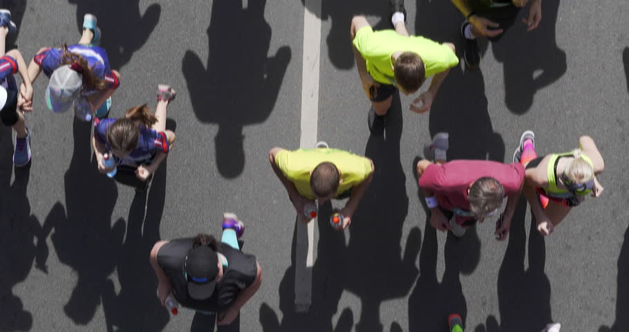 4K - Blurred motion of marathon. top view