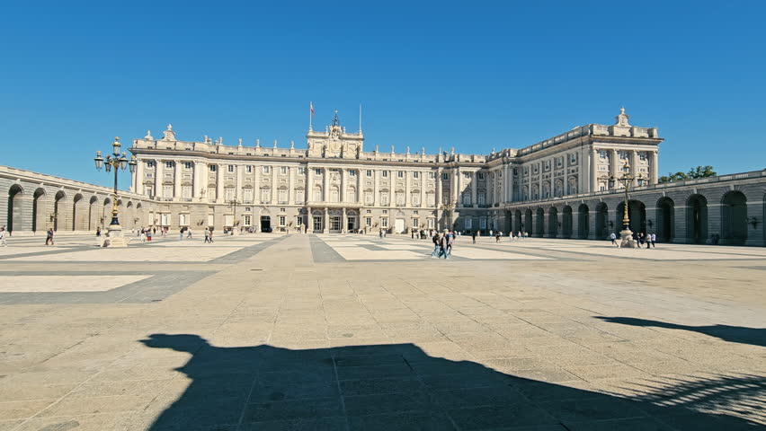 Spain, Madrid 29.11.2024 Royal Palace of Madrid, A wide-angle view of the Royal Palace of Madrid, showcasing its grand architecture and visitors enjoying the plaza.