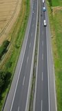 Timelapse, vertical slider video: cars are driving on the road in the afternoon - static aerial top view. 