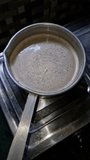 Slow motion video of tea making in a saucepan and making a swirl effect when stirred 