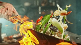 Super Slow Motion of Flying Asian Noodles with Vegetable and Prawns. Chef is Pouring Salt in the Meal. Filmed on High Speed Cinema Camera, 1000 fps. - Powered by Shutterstock - Get 15% off with code: PIKWIZARD15