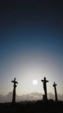 Redemption concept. Three crosses on the Golgotha hill with beautiful clouds fast moving on the blue sky. Resurrection, new life, Easter. Vertical video
