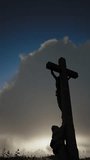 The camera zooms in on the Cross at the top of Mount Golgotha. Fast moving clouds in the blue sky. The concept of redemption, Easter. vertical video. Beautiful 3D rendering
