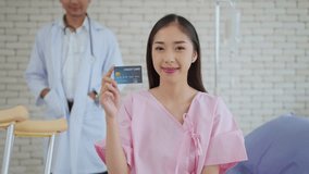 Beautiful young Asian woman patient holding credit card or insurance card, smiling to camera. Payment medical treatment. Health care and insurance concept. Medical and health care concept - Powered by Shutterstock - Get 15% off with code: PIKWIZARD15