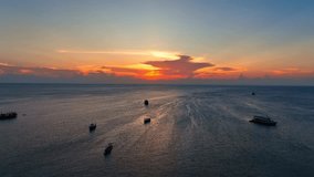 Mesmerizing drone vista captures the boundless sea merging with the golden sunset on the horizon, an infinite embrace of nature's beauty. Flight over the sea. Cinematic footage. Ocean background. 4K.
