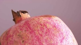 Macro detail of the pomegranate fruit. Natural nutrition and fruit and vegetable concept idea. Rotating on front view.