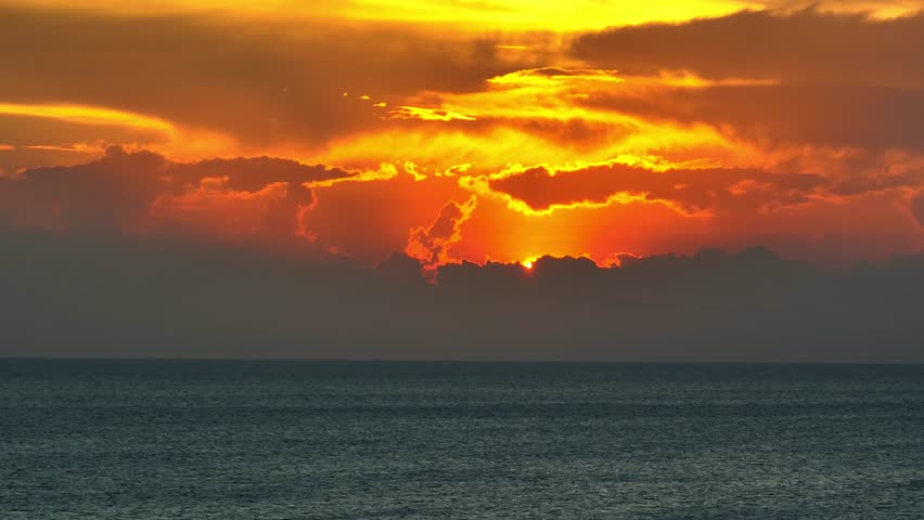 Vivid hues blend as sun dips, painting the vast expanse with twilight