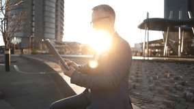 mature businessman, outdoors in a meeting with digital tablet - Powered by Shutterstock - Get 15% off with code: PIKWIZARD15