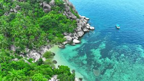 From above, witness a ship amidst snorkeling tourists in the mesmerizing turquoise waters of a tropical oasis. An aerial spectacle of beauty unfolds. Koh Tao, Southern Thailand. Island background. 4K.