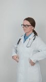 In this video, a young doctor stands in her office, expressing confidence and energy in front of the camera. Her professional appearance and determination are impressive, and her posture reflects her