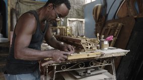 Artisan luthier working on creation of wooden piano. Making handmade musical instruments in workshop - Powered by Shutterstock - Get 15% off with code: PIKWIZARD15