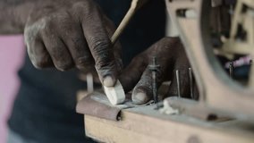 Close up of luthier's hands working on creation of wooden musical instrument, repairing old piano keyboard - Powered by Shutterstock - Get 15% off with code: PIKWIZARD15