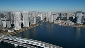 Aerial video of roads and bridges in Tokyo city on a sunny day, Japan