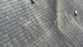 Roof with hail damage and chalk markings from inspection