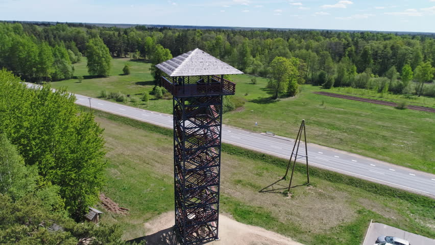 Aerial drone orbit shot of a watchtower revealing raised bog in Teiči Nature Reserve (Teiču dabas rezervāts), Latvia