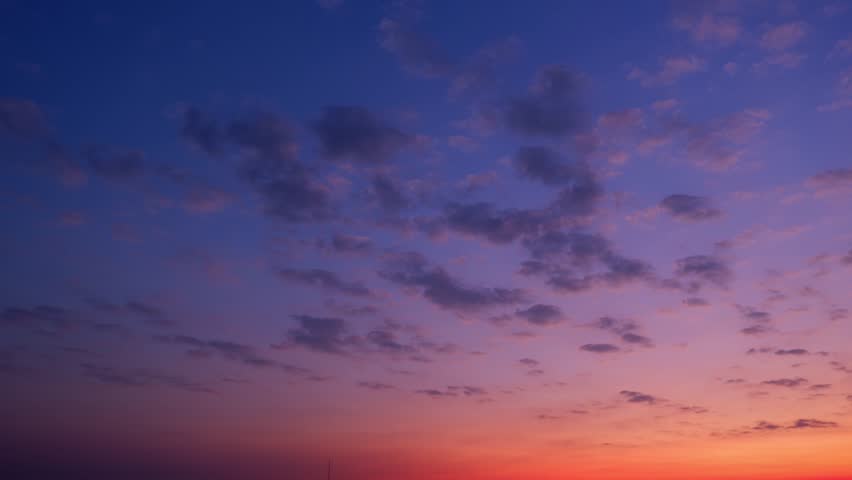 4K : Sunset sky time lapse : The sunset time-lapse sky transforms into a canvas of vibrant hues. Wispy clouds gracefully dance across the horizon, painting a timelapse spectacle. 
