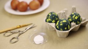 The video shows the stage of coloring eggs for Easter. space egg design