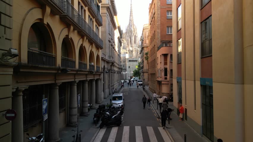Aerial video goes up over the streets of Barcelona towards the Barcelona Cathedral. A famous historic Gothic landmark in the Old City district. Aerial panoramic view of the city. Barcelona, Spain Royalty-Free Stock Footage #3449767065