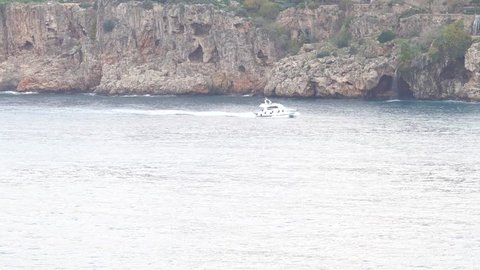 Cliff on the land coast with motor boat