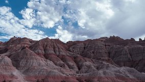 The Badlands are a vast and desolate landscape of eroded rock formations, carved by millions of years of wind and water. The timelapse video of passing clouds over the Badlands is a mesmerizing sight,