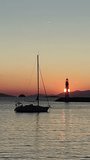 lighthouse on the coast of state country. Seascape at sunset. Lighthouse on the coast. Seaside town of Turgutreis and spectacular sunsets. Vertical video for social media.