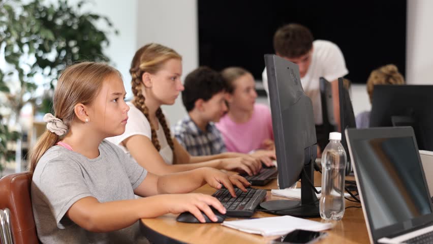 Curious underage girl engaged in IT training during computer courses for children Royalty-Free Stock Footage #3449865217