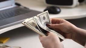 close-up of female hands counting a stack of hundred-dollar US banknotes. a businesswoman is counting cash. the concept of investment, money exchange, bribes or corruption. 4K - Powered by Shutterstock - Get 15% off with code: PIKWIZARD15