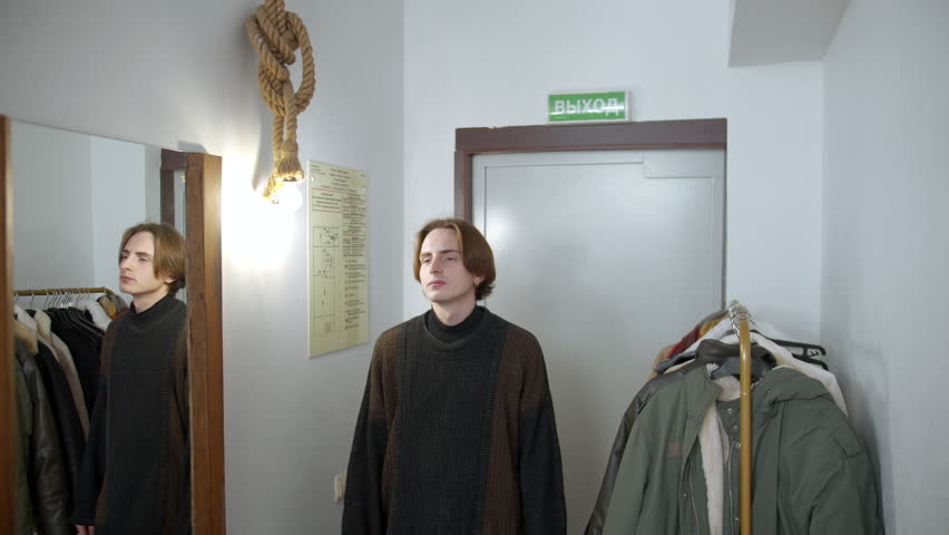 Young man check in at a hotel. Media. Happy receptionist giving a key to a man at the reception desk, concept of travelling.