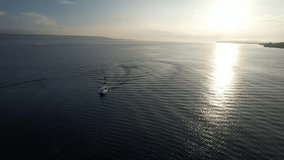 Aerial Boat sunrise over ocean in moyo island sumbawa with tambora mt view
