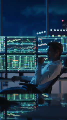 Vertical Portrait of Financial Analyst Working on Computer with Multi-Monitor Workstation with Real-Time Stocks, Commodities and Foreign Exchange Charts. Businessman Works in Investment Bank. Royalty-Free Stock Footage #3449993017