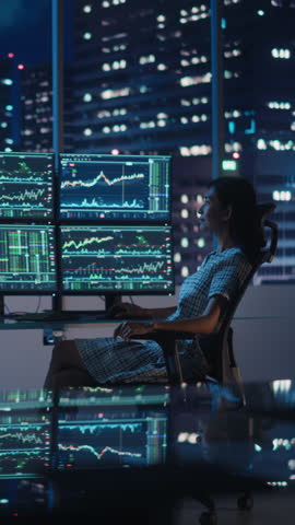 Vertical Portrait of a Financial Analyst Working on Computer with Multi-Monitor Workstation with Real-Time Stocks, Commodities and Exchange Market Charts. Businesswoman at Work in Investment Agency. Royalty-Free Stock Footage #3449993073