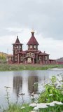 Orthodox Church in the village of Mauk, Chelyabinsk region, Russia. The wooden temple was built by local residents at their own expense. Christian faith in God. Vertical video for shorts.